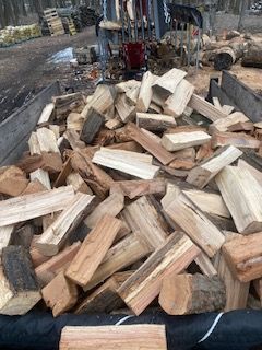 A dump truck with a tree chipper attached to it is parked on the side of the road.