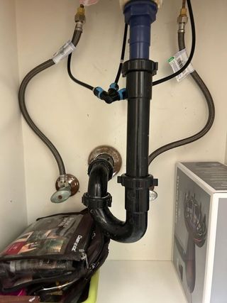 A kitchen sink with a hose attached to it