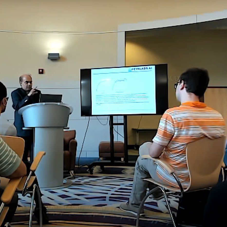 A man giving a presentation in front of a screen that says project