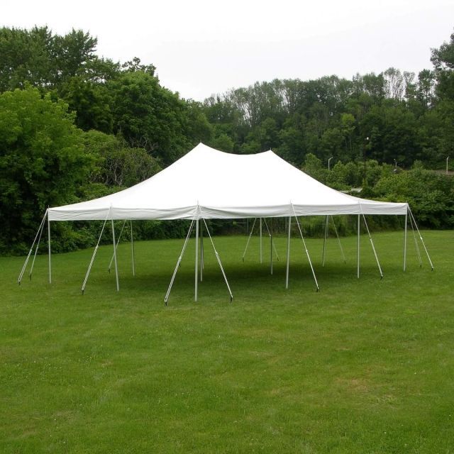 Long wedding table set outdoors with floral centerpieces, and gold chargers.
