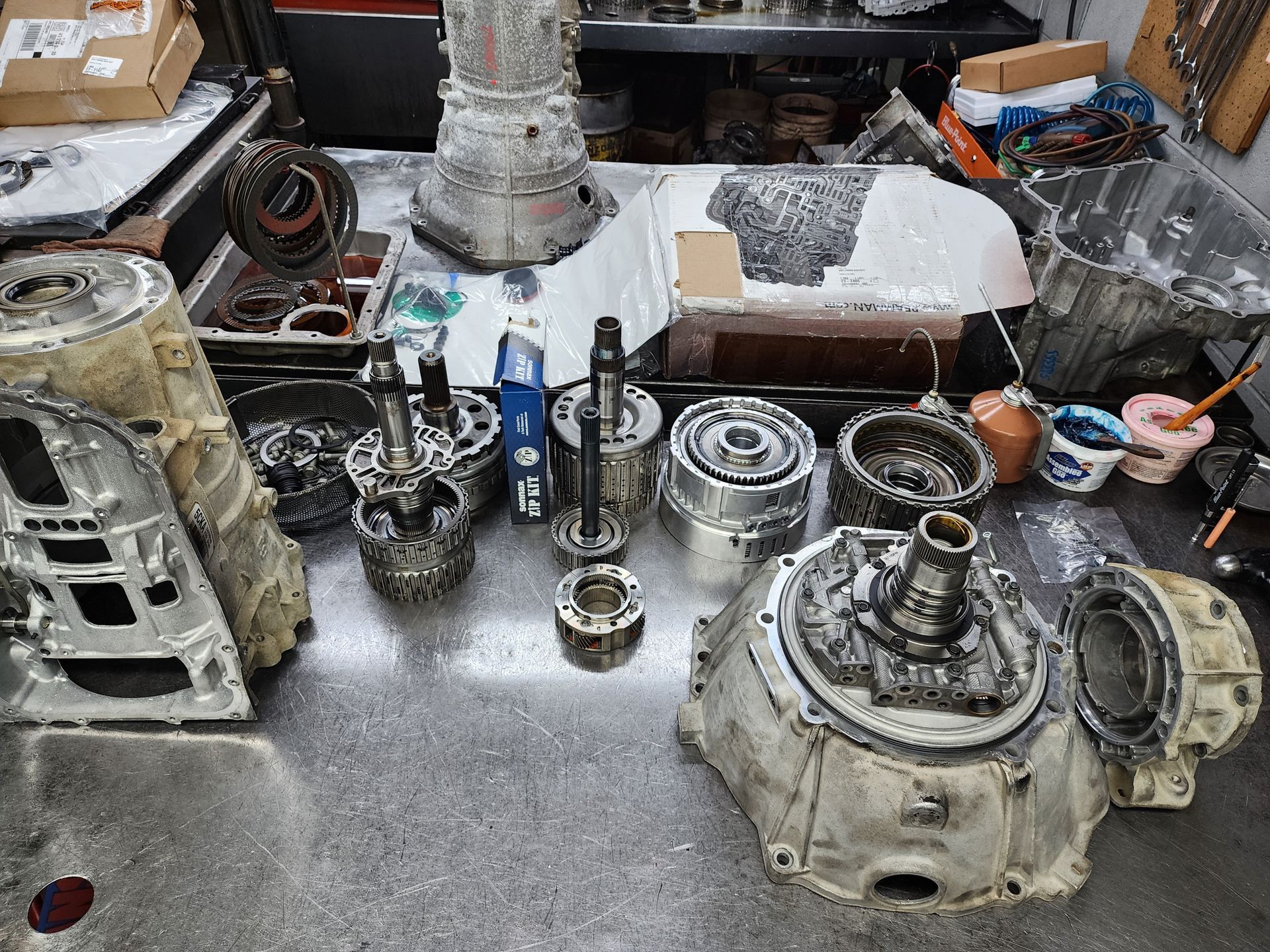 Cutaway view of a metallic gearbox with multiple gears, showcasing internal mechanisms.