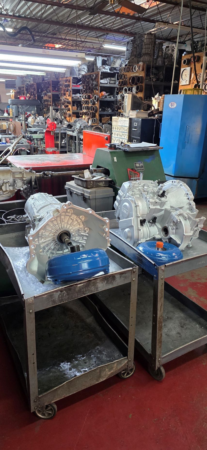 Cutaway view of a car transmission showing gears and internal components in a metallic housing.