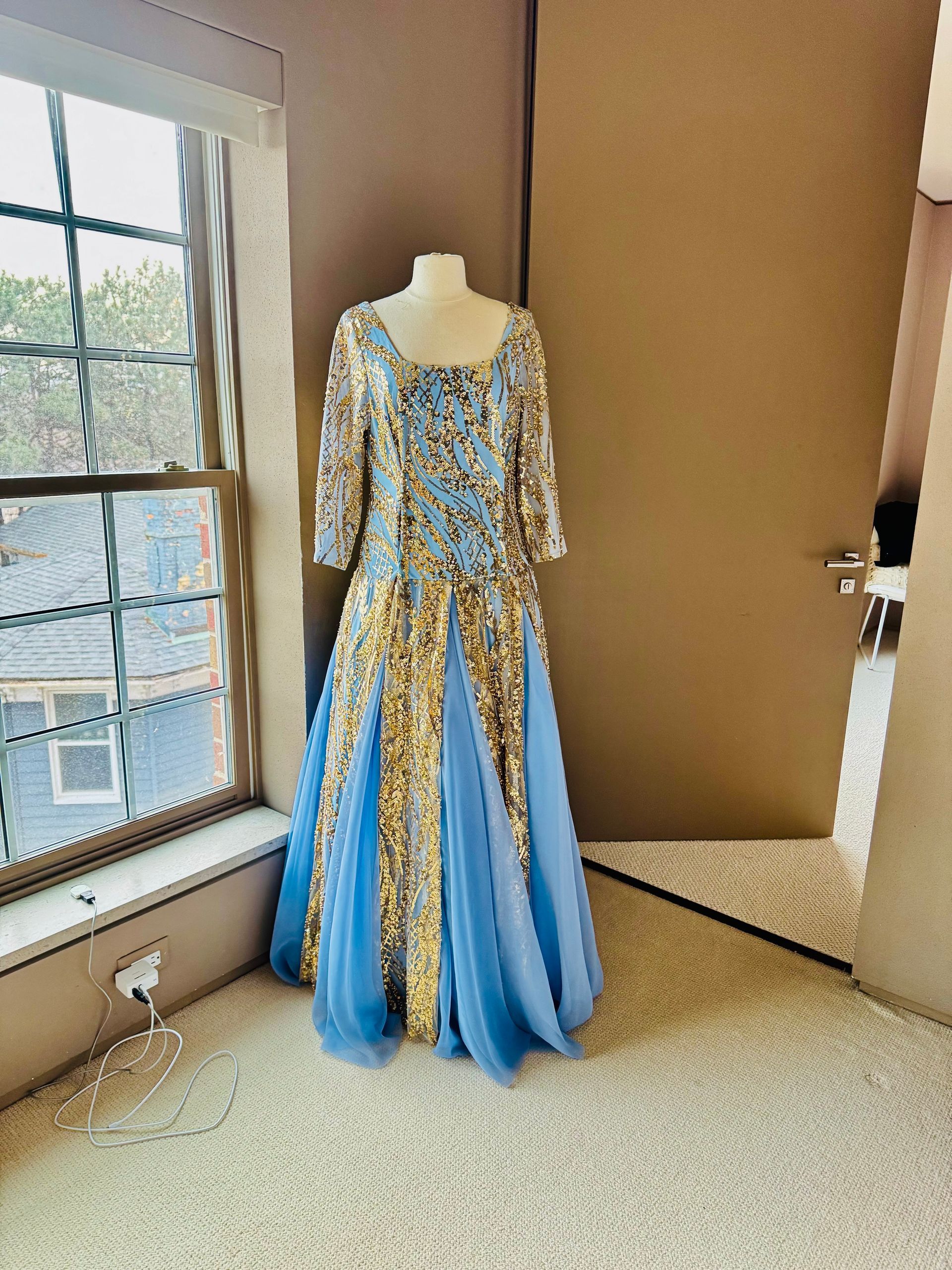 Tailor's mannequin with partially sewn suit jacket and measuring tape.