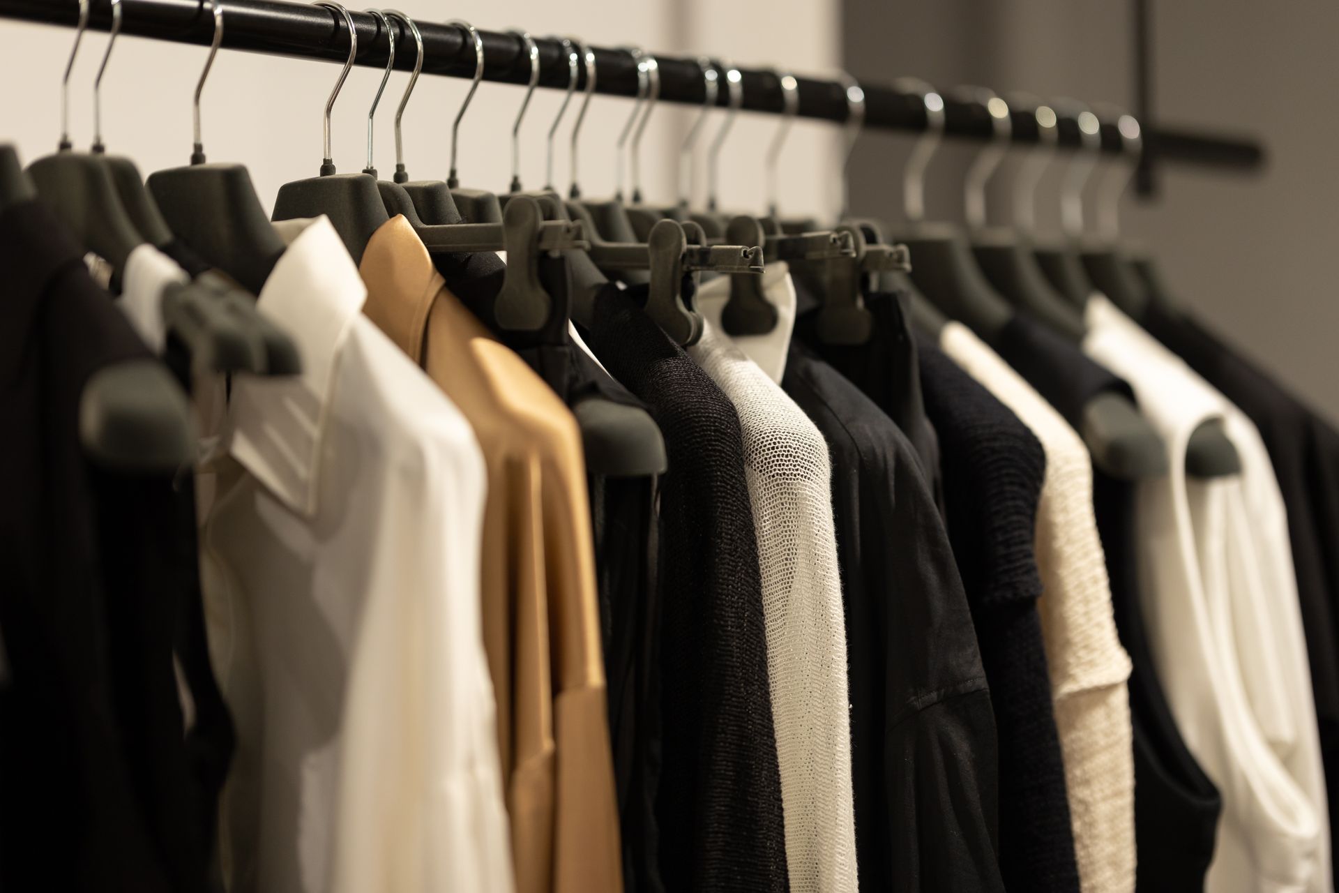 Blue plaid shirt hanging on a rack in a store. Blurred background. After being dry cleaned.