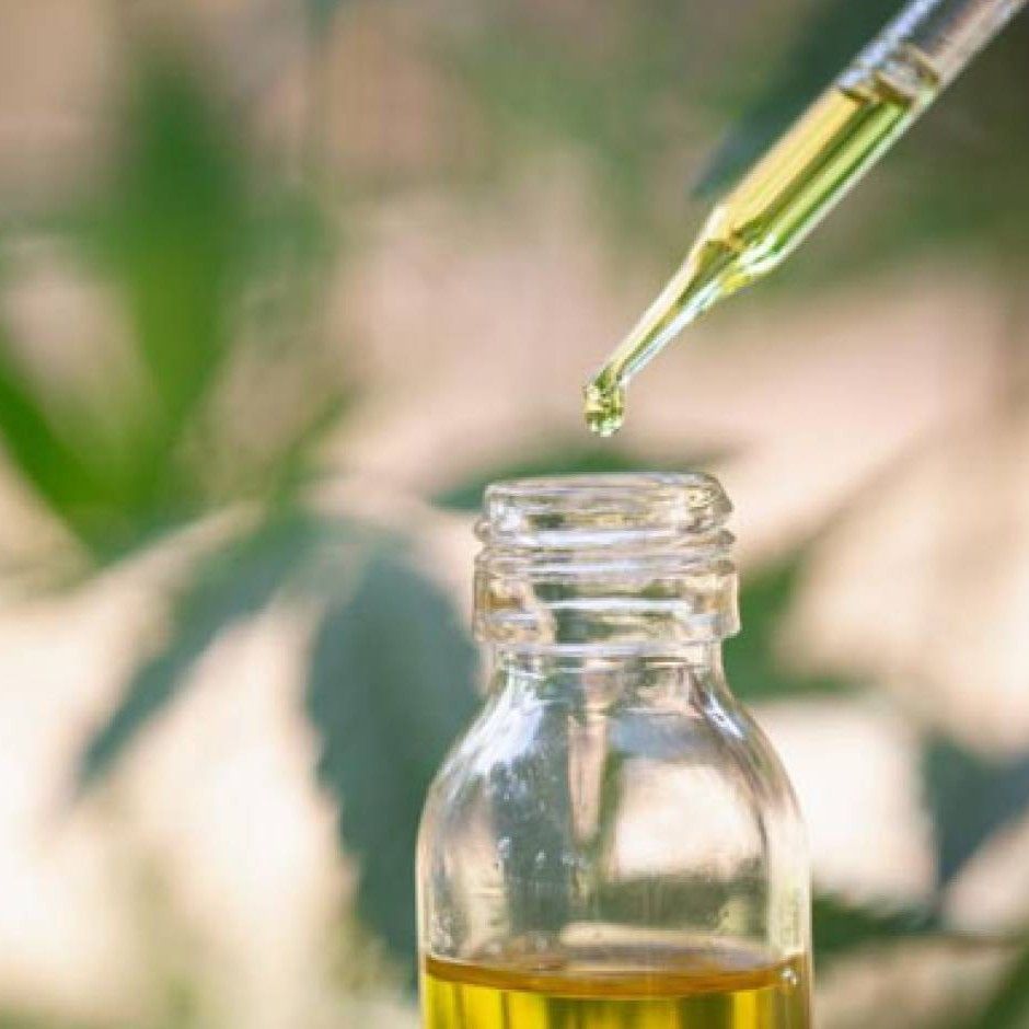 Picture of a dropper being pulled from a tincture bottle.