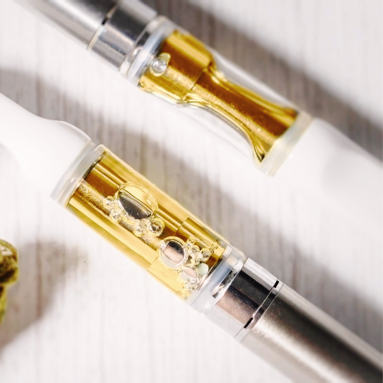 Close up image of a vape cartridge filled with cannabis concentrate.