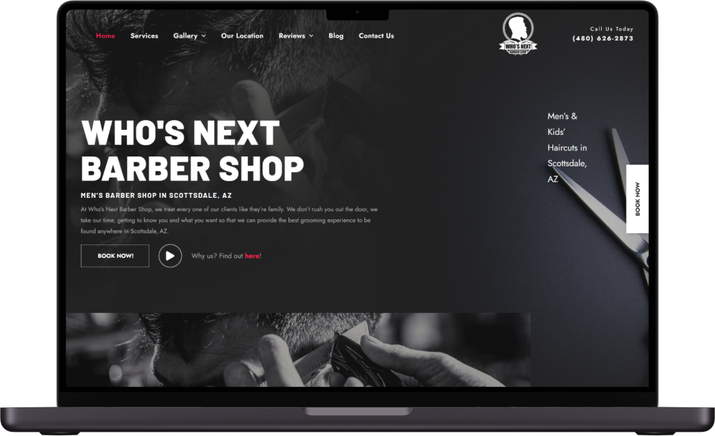 A laptop is open to a website for a barber shop.