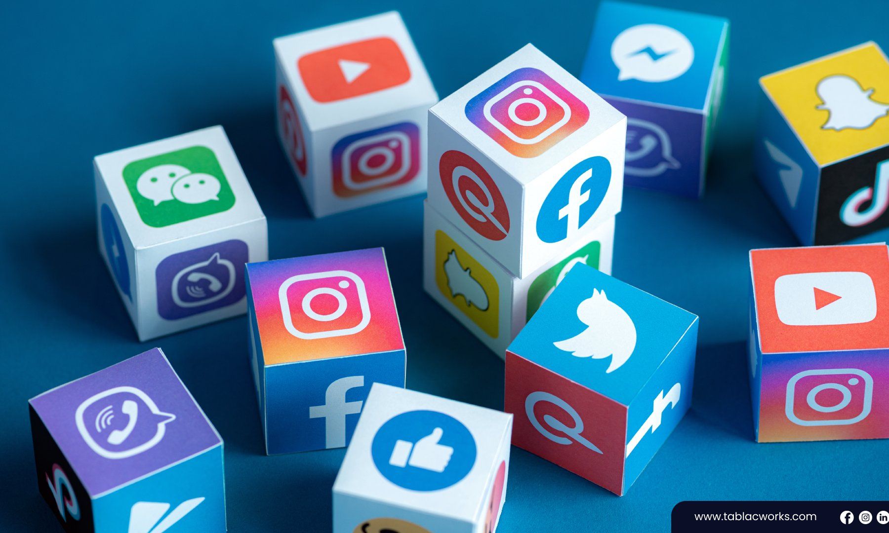 A bunch of cubes with social media icons on them