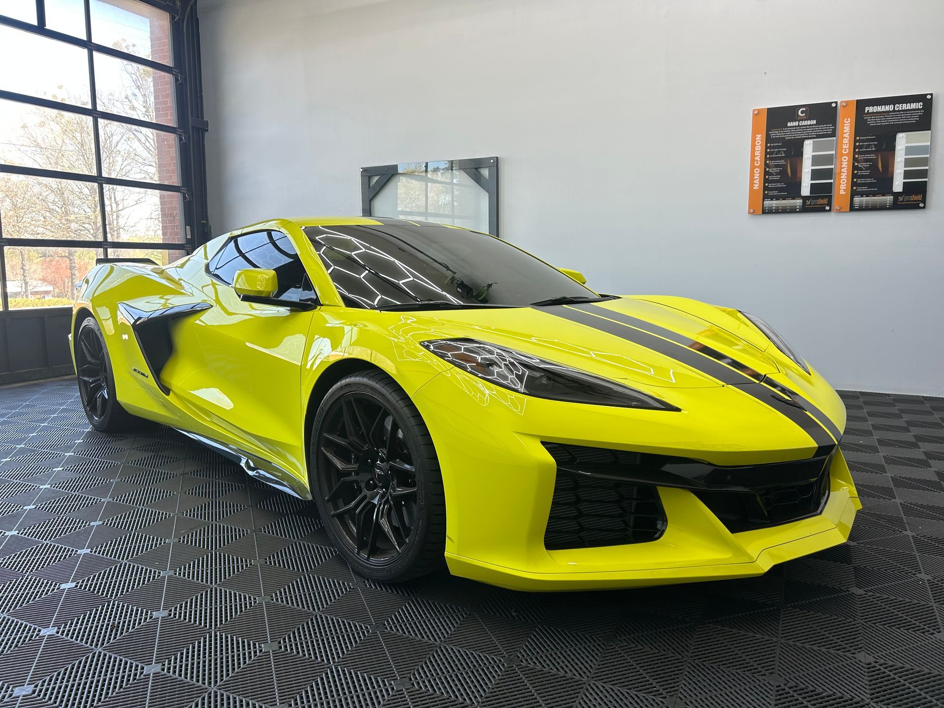 A yellow sports car is parked in a garage.