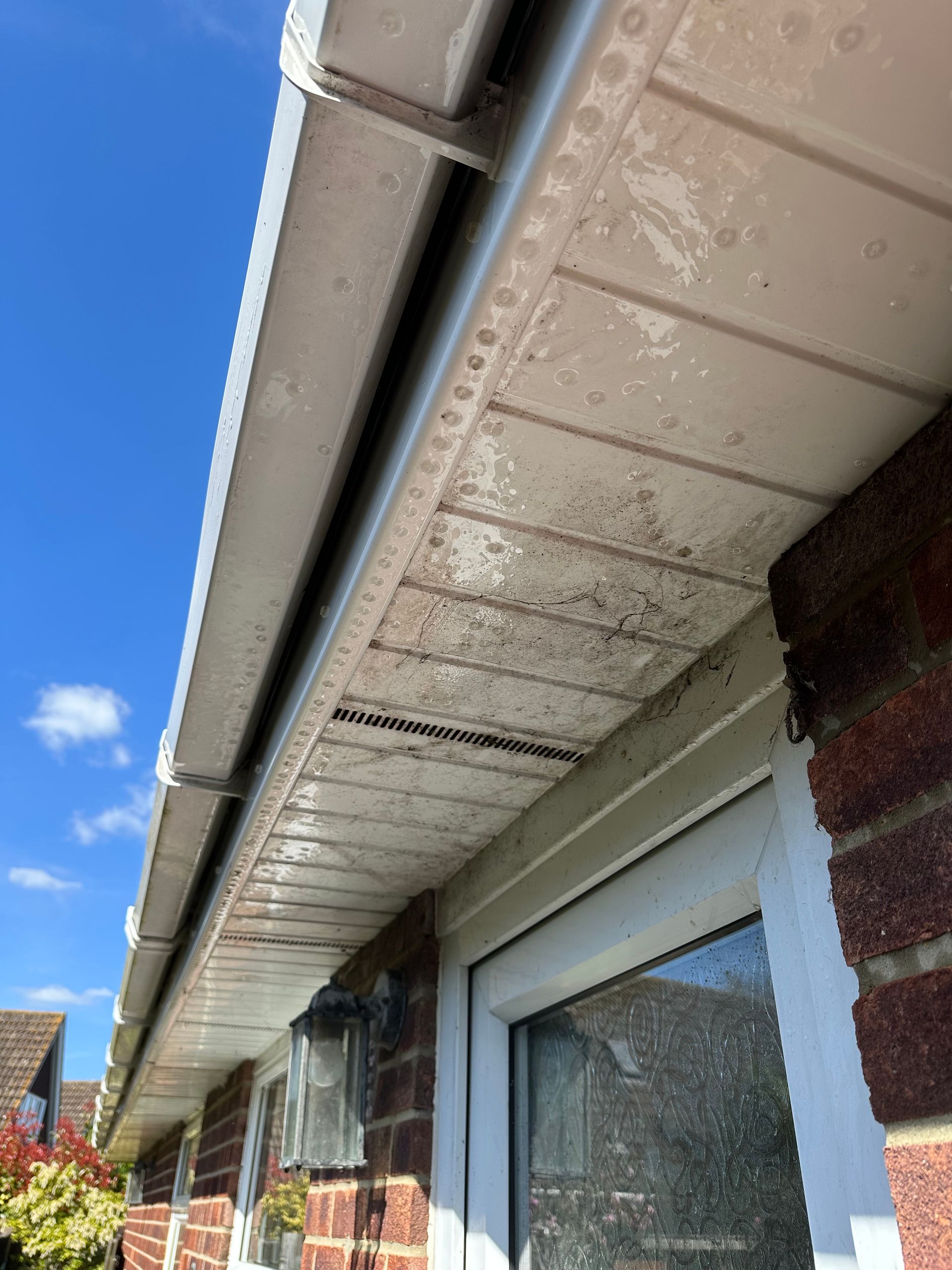 A modern house with a balcony and a glass railing.