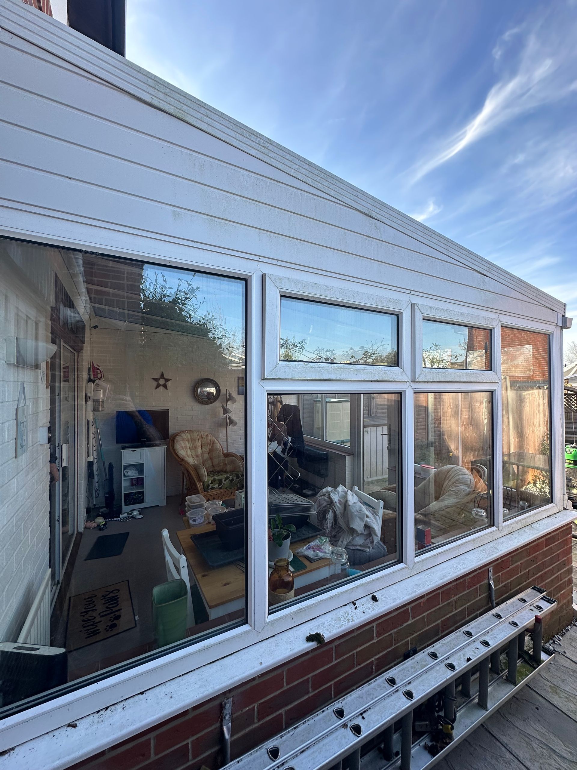 An aerial view of a small house in the middle of a field.