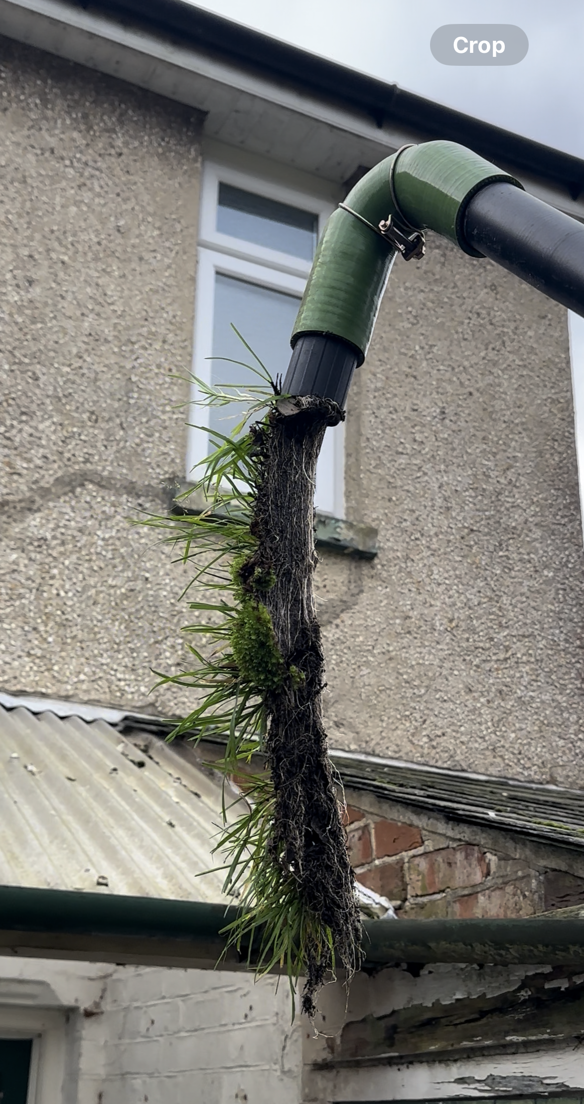The rain is falling on the roof of a house.
