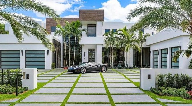 Driveway of Modern Palm Beach Home with large modern pavers and artificial in Palm Beach, Florida