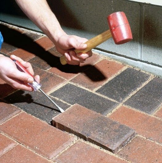 Paver Repair using a screwdriver and mallet