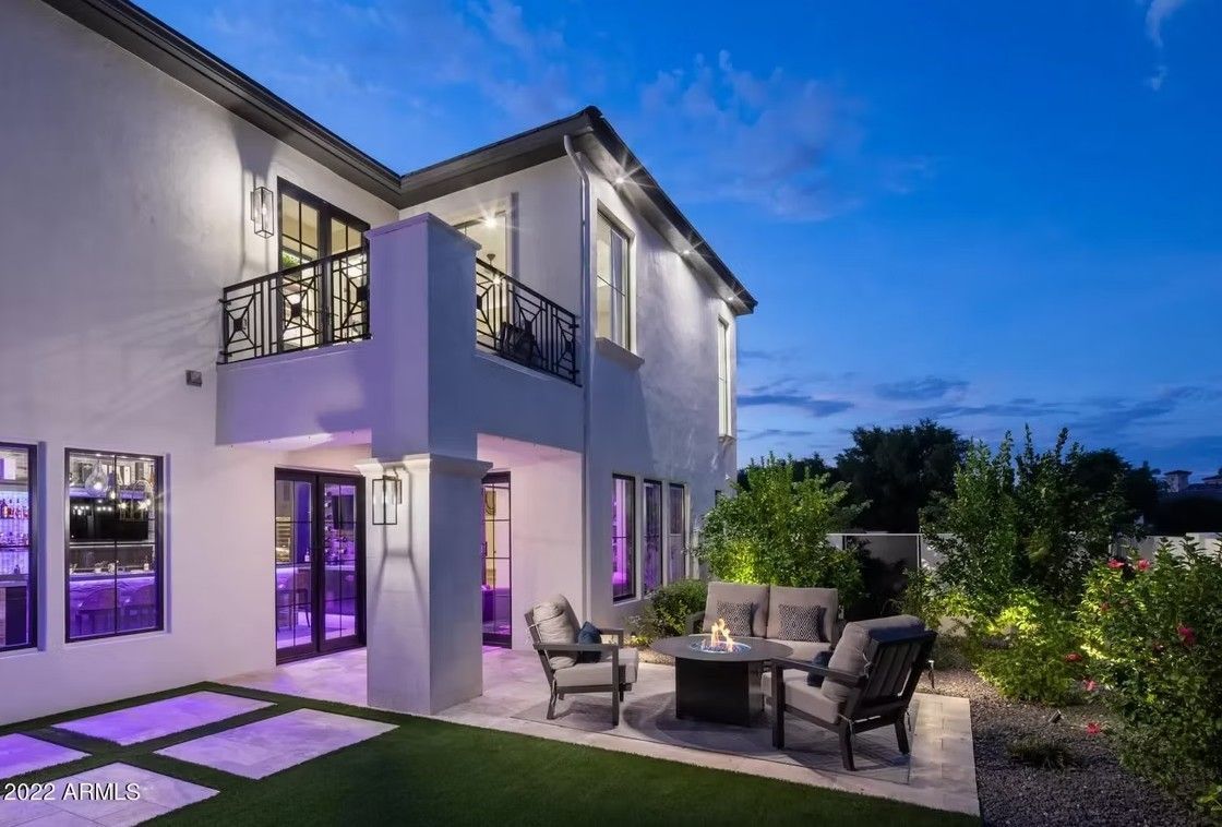 While Home with large concrete pavers and artificial grass