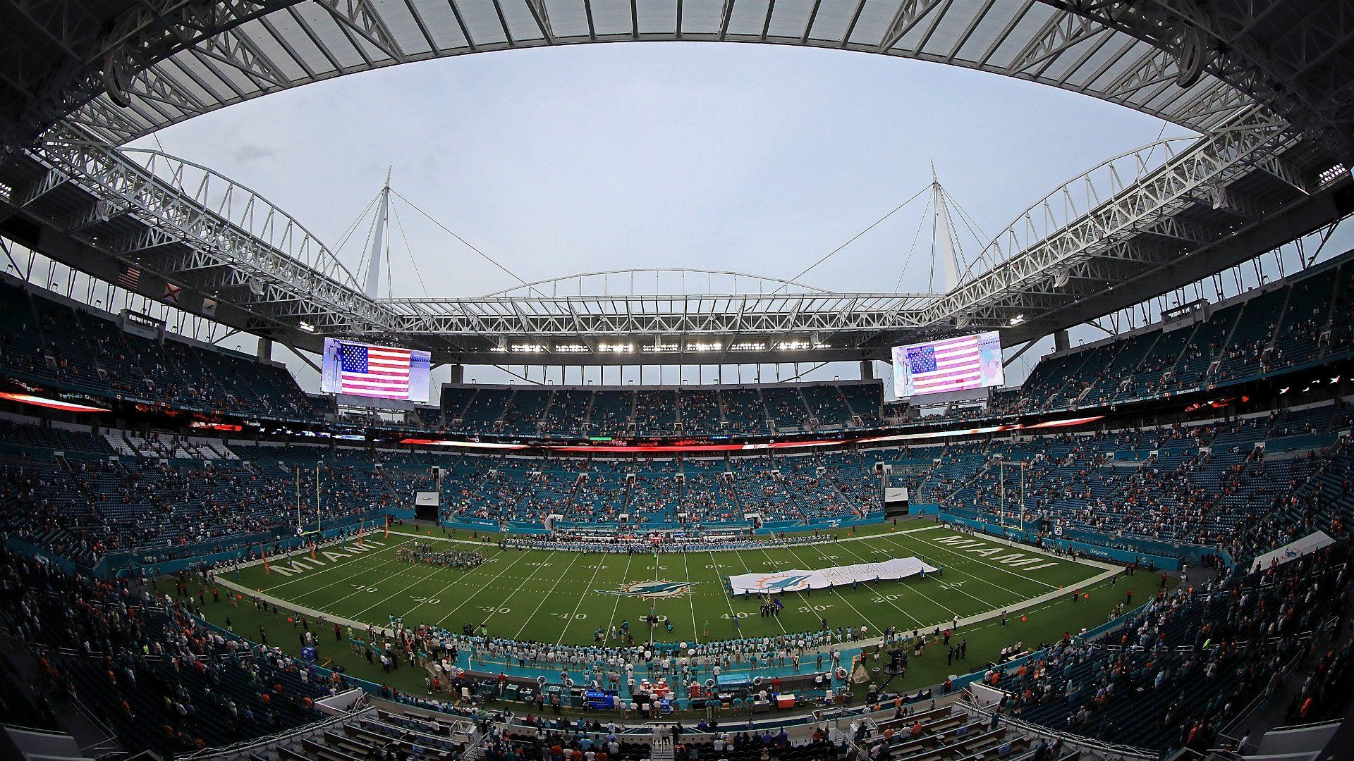 A stadium filled with people watching a football game.