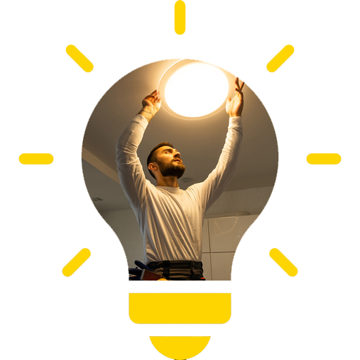 A man is changing a light bulb on the ceiling.