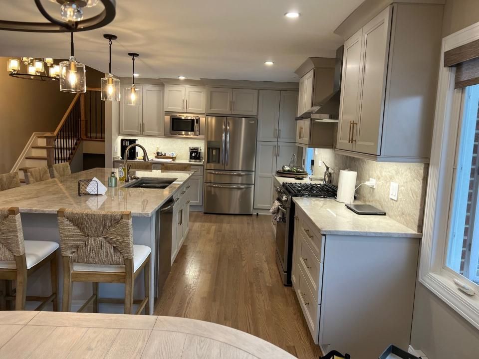 A man is working on a counter in a kitchen.