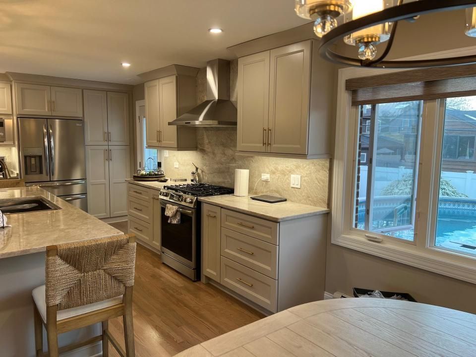 A kitchen with a dining table and chairs in it.