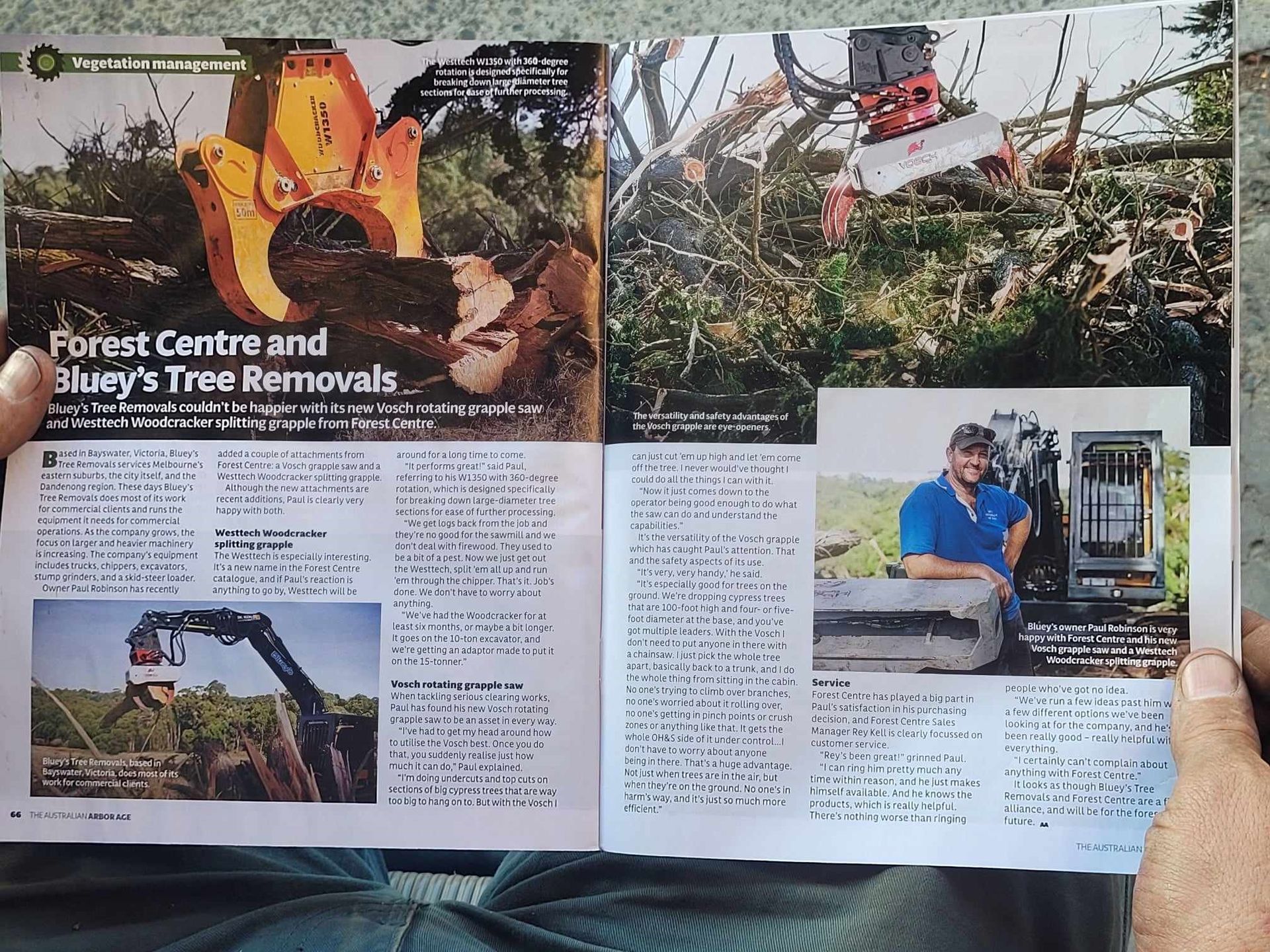 A person is reading a magazine about forest centre and bluey 's tree removals
