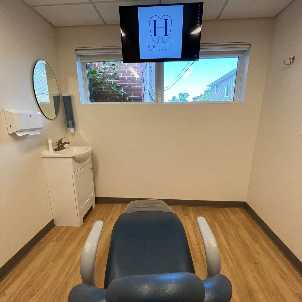 A Dental Office With a Chair and a TV Above It - Buffalo, NY - Hertel Family Dentistry
