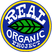 Logo for Real Organic Project: blue and yellow circular design with white text and a green leaf, promoting organic practices.
