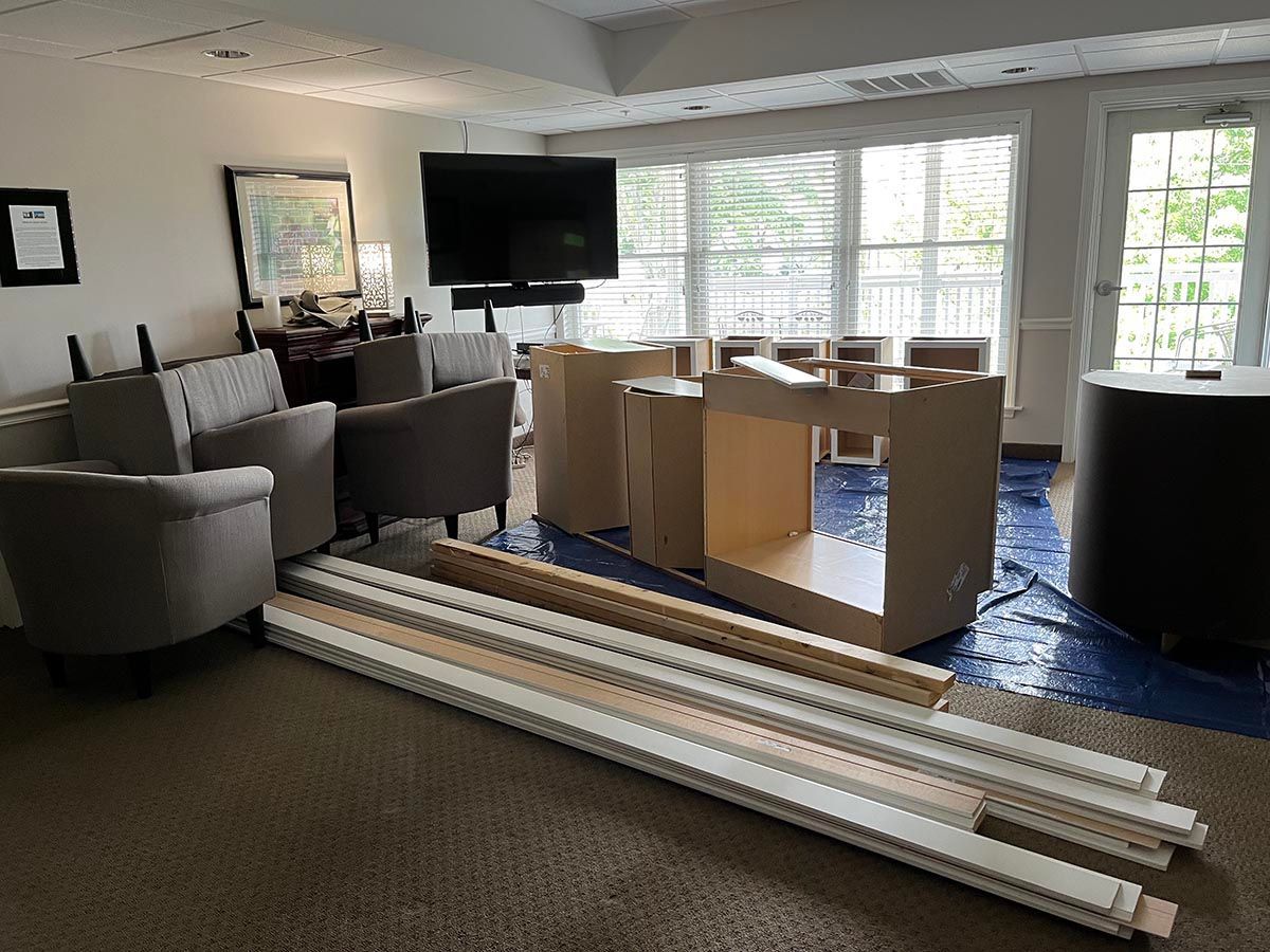 A living room with a lot of furniture and a tv on the wall.