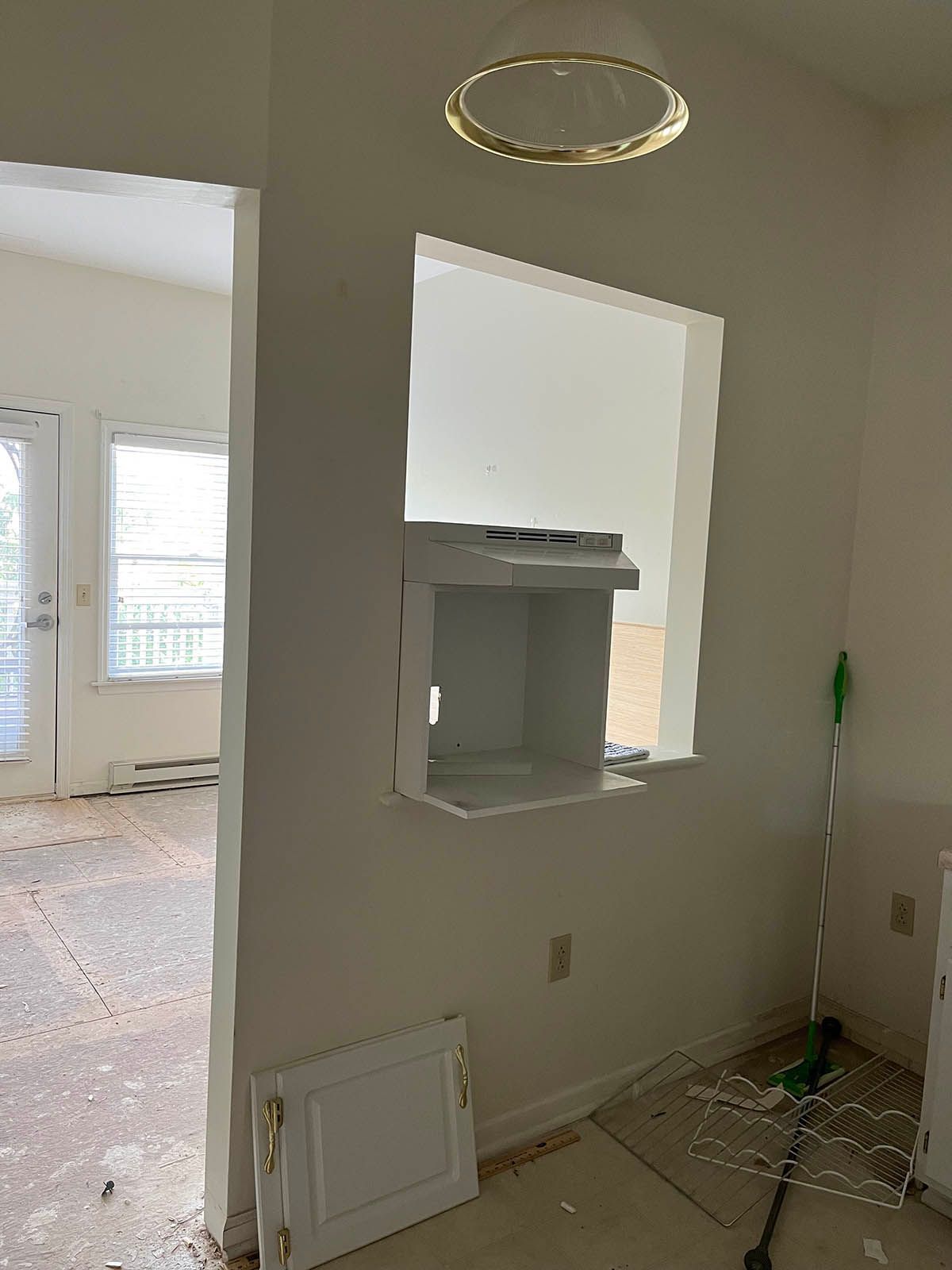 There is a window in the wall between the kitchen and the living room.