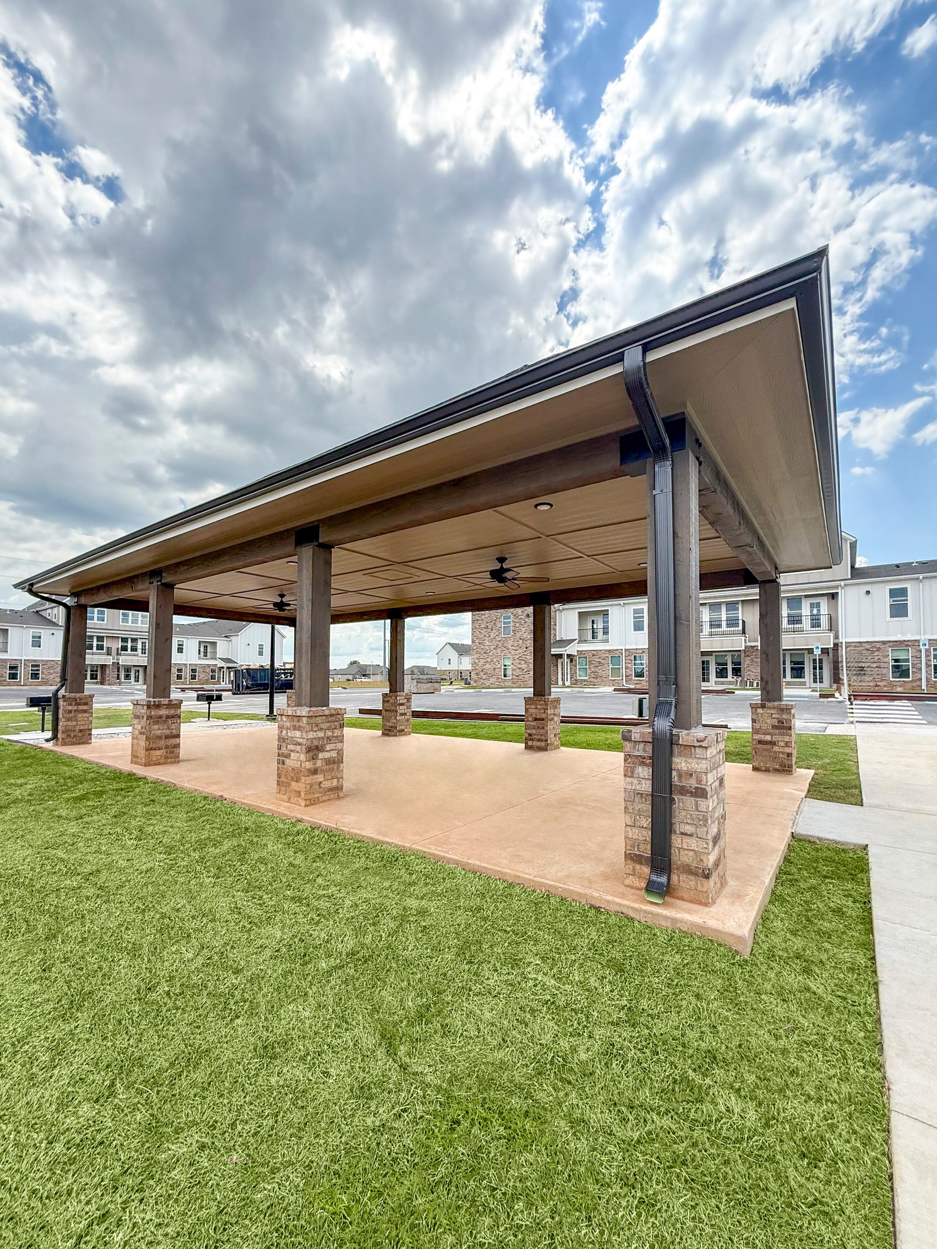 A pavilion is sitting in the middle of a lush green field.