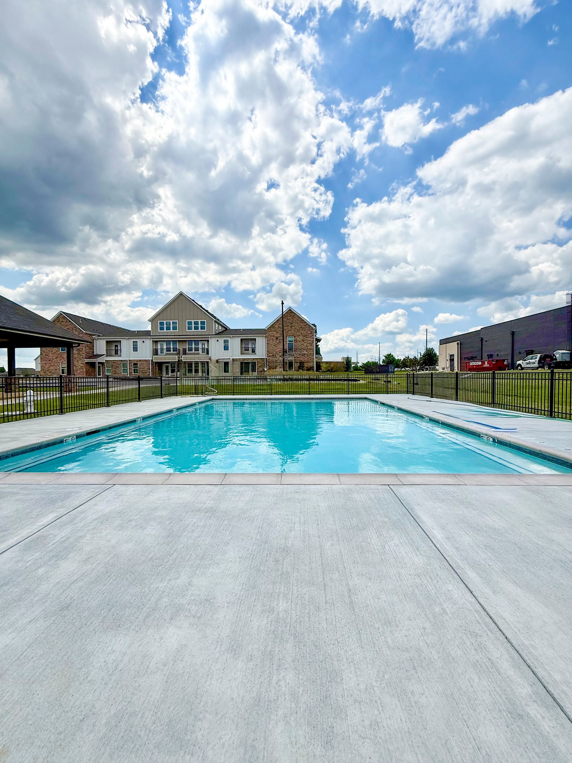 A large swimming pool with a building in the background