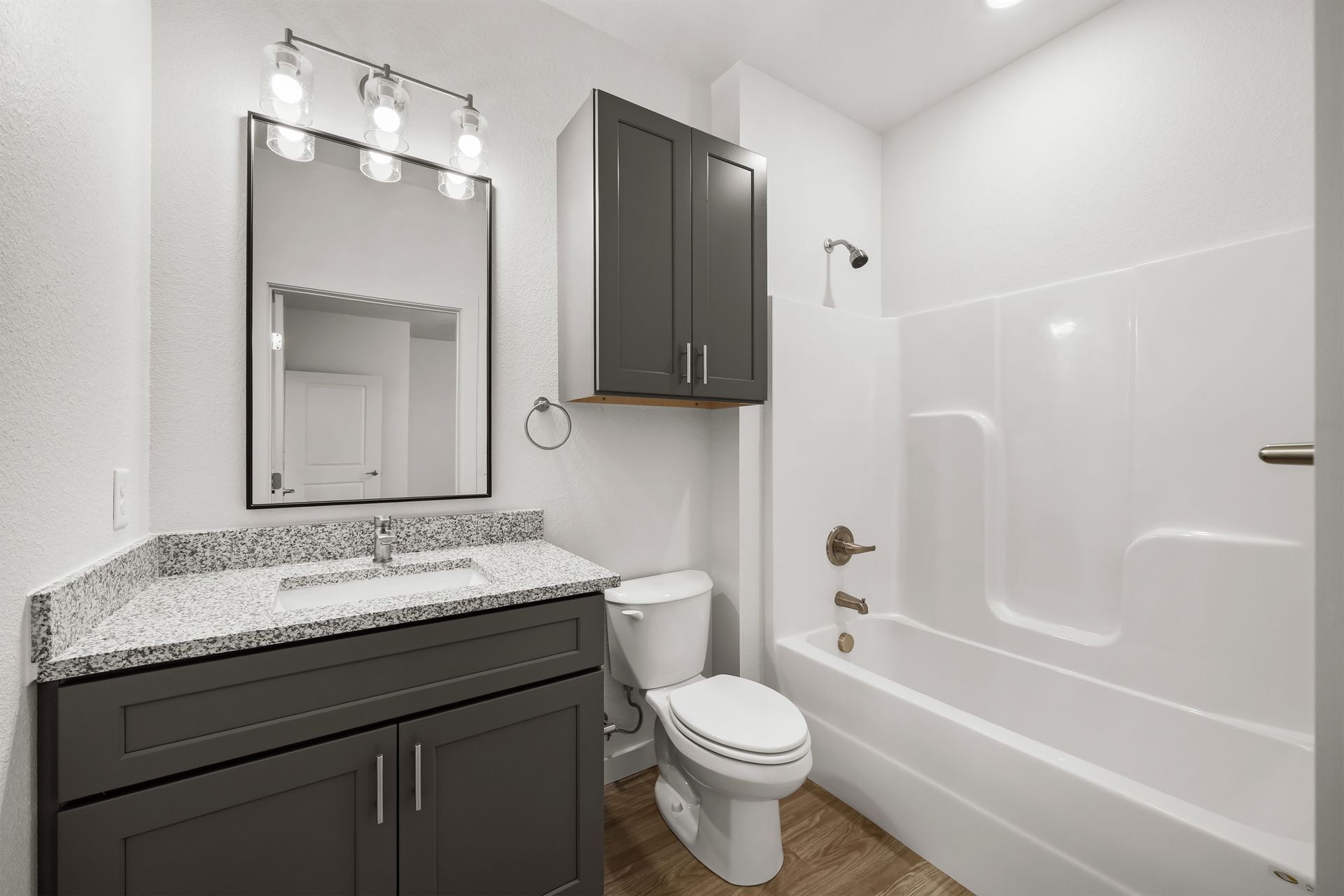A bathroom with a toilet , sink , and bathtub.