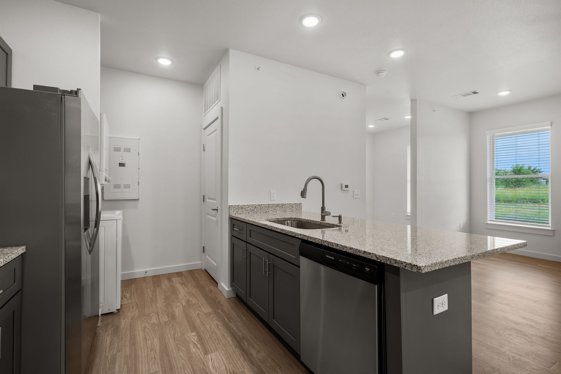 A kitchen with stainless steel appliances and granite counter tops.