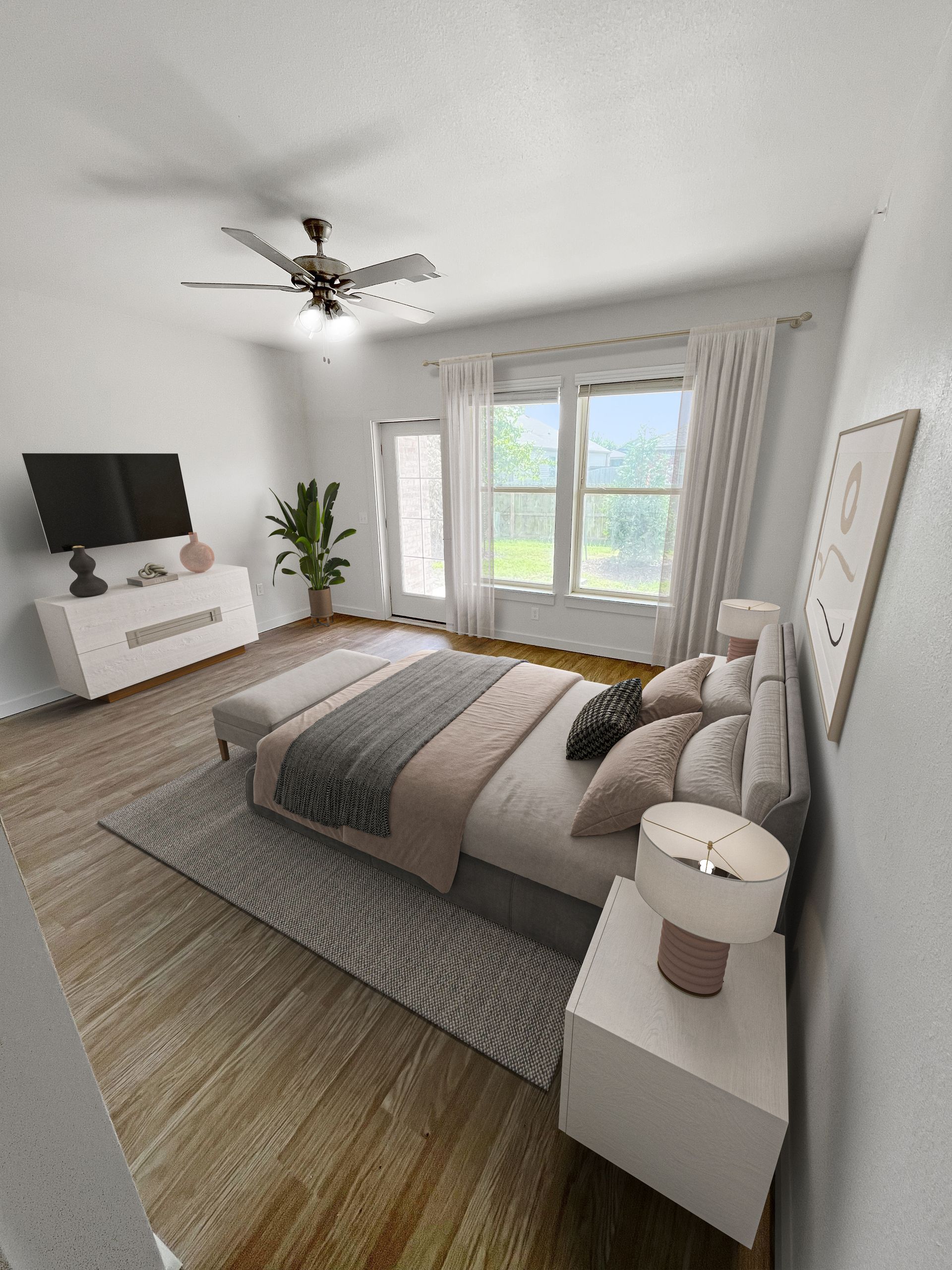 A bedroom with a bed , nightstand , television and ceiling fan.