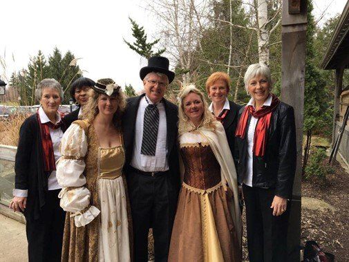 An image of 7 people dressed in period costumes.