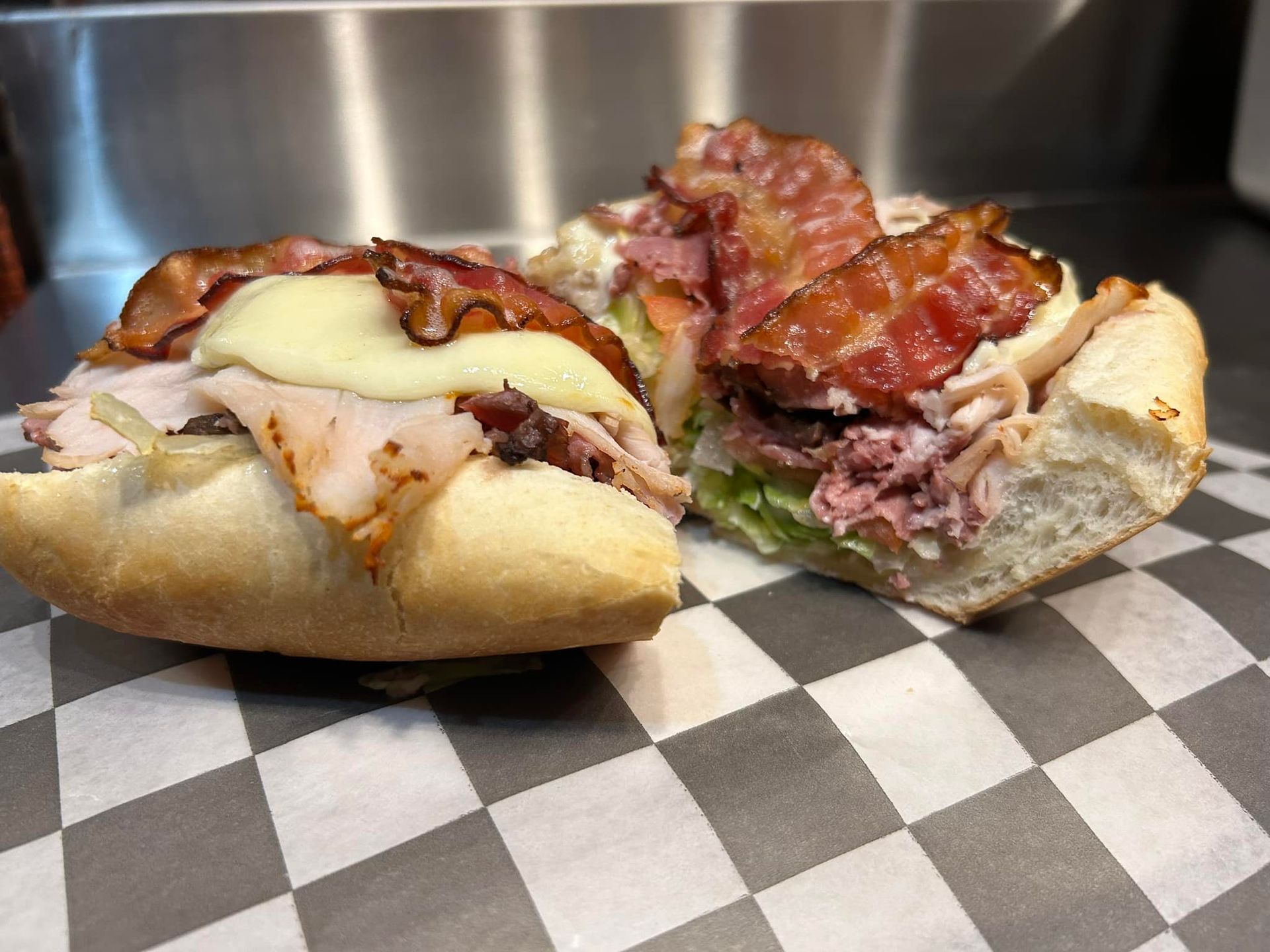 A room with tables and chairs in front of a large window.