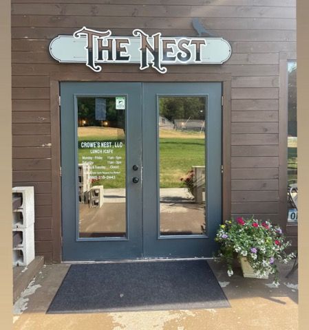 A store front with a sign that says the nest