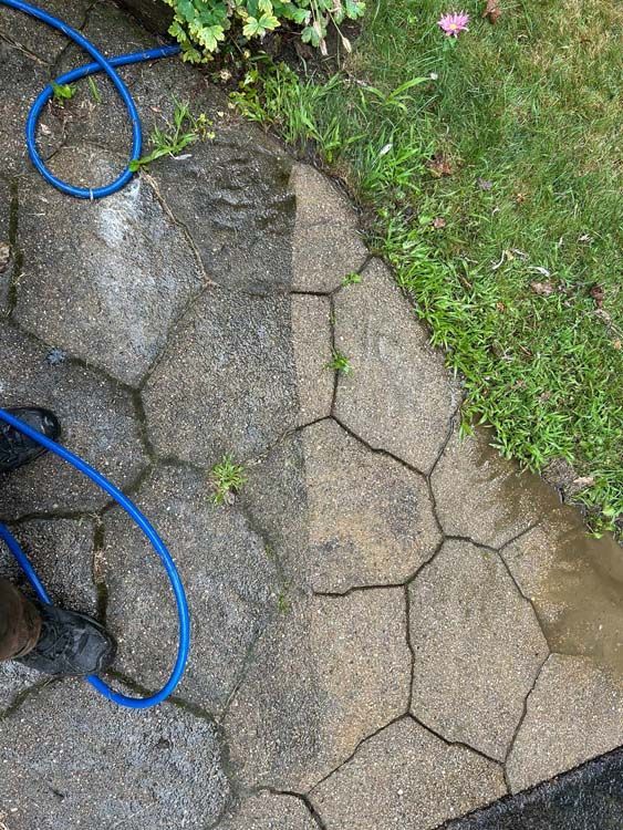 Patio being cleaned with a pressure washer