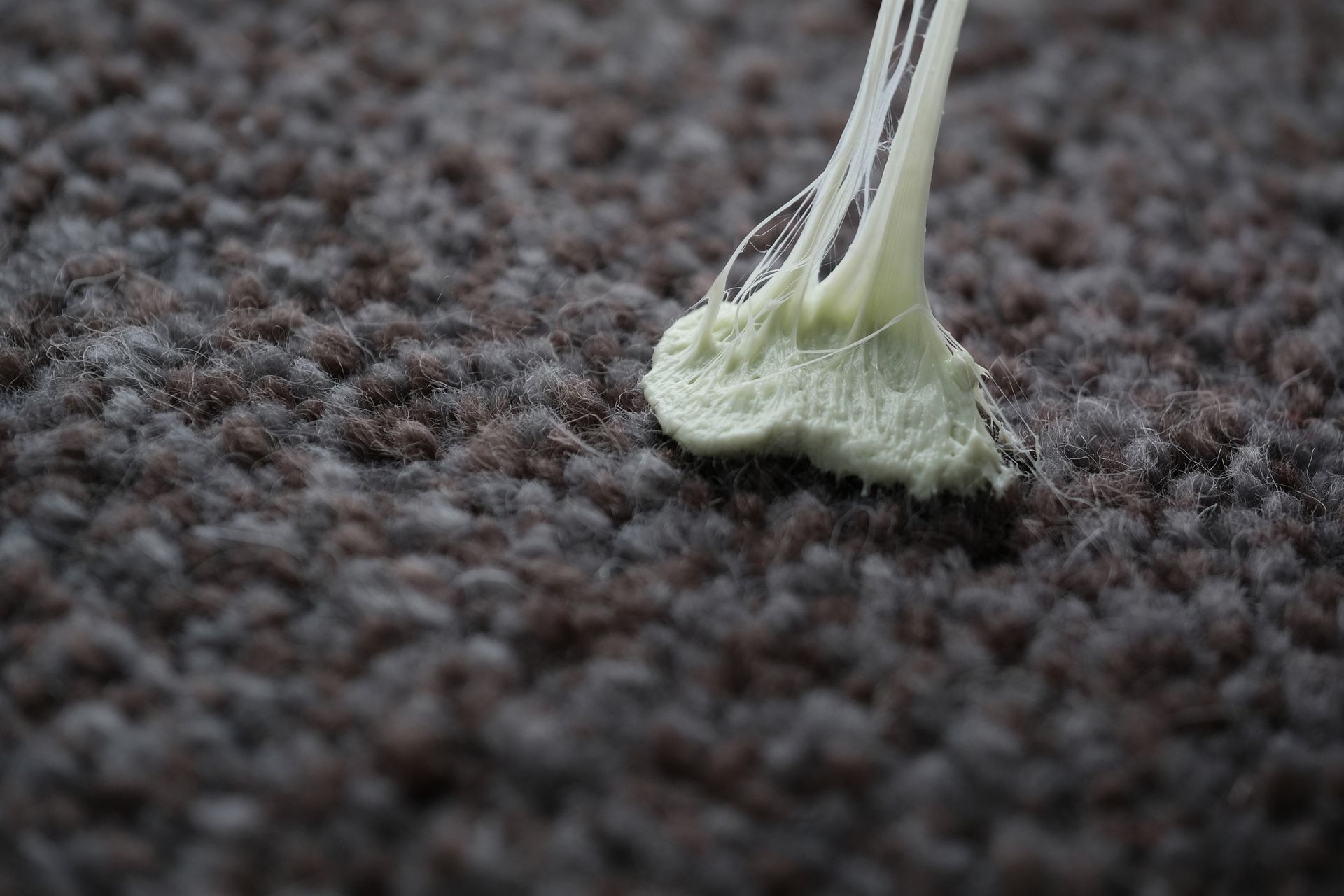 Gum stuck to brown carpet