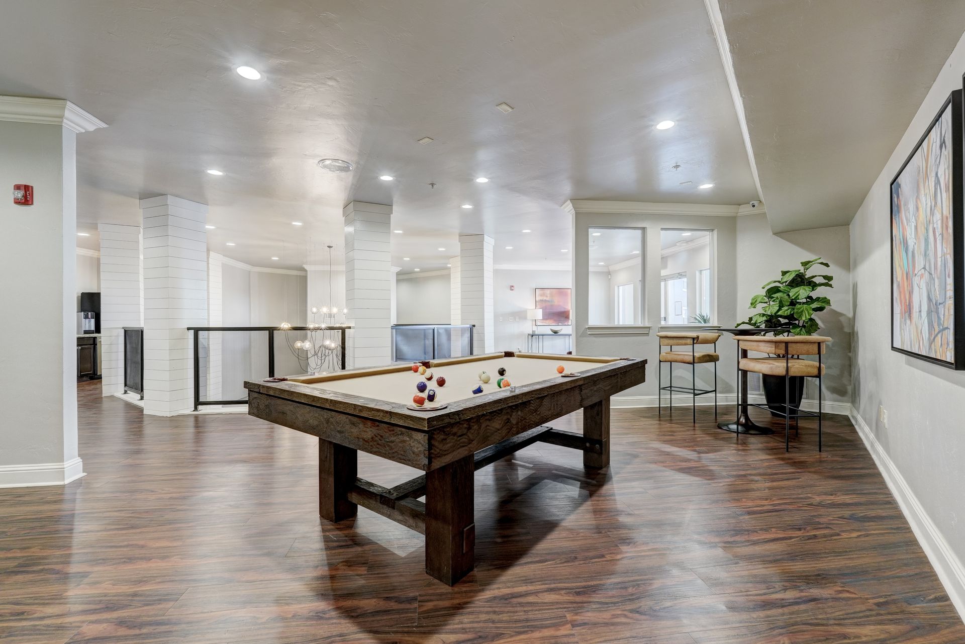 There is a pool table in the middle of the room.