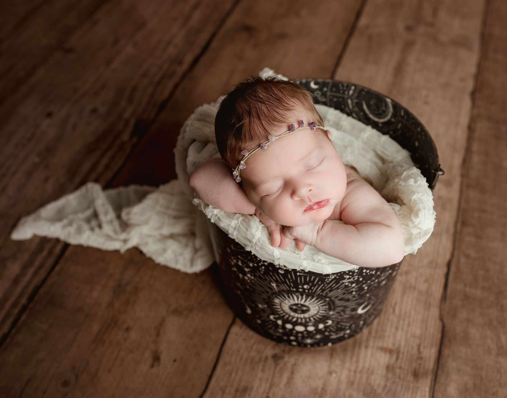 Newborn posed in a bucket, celestial newborn photo ideas.