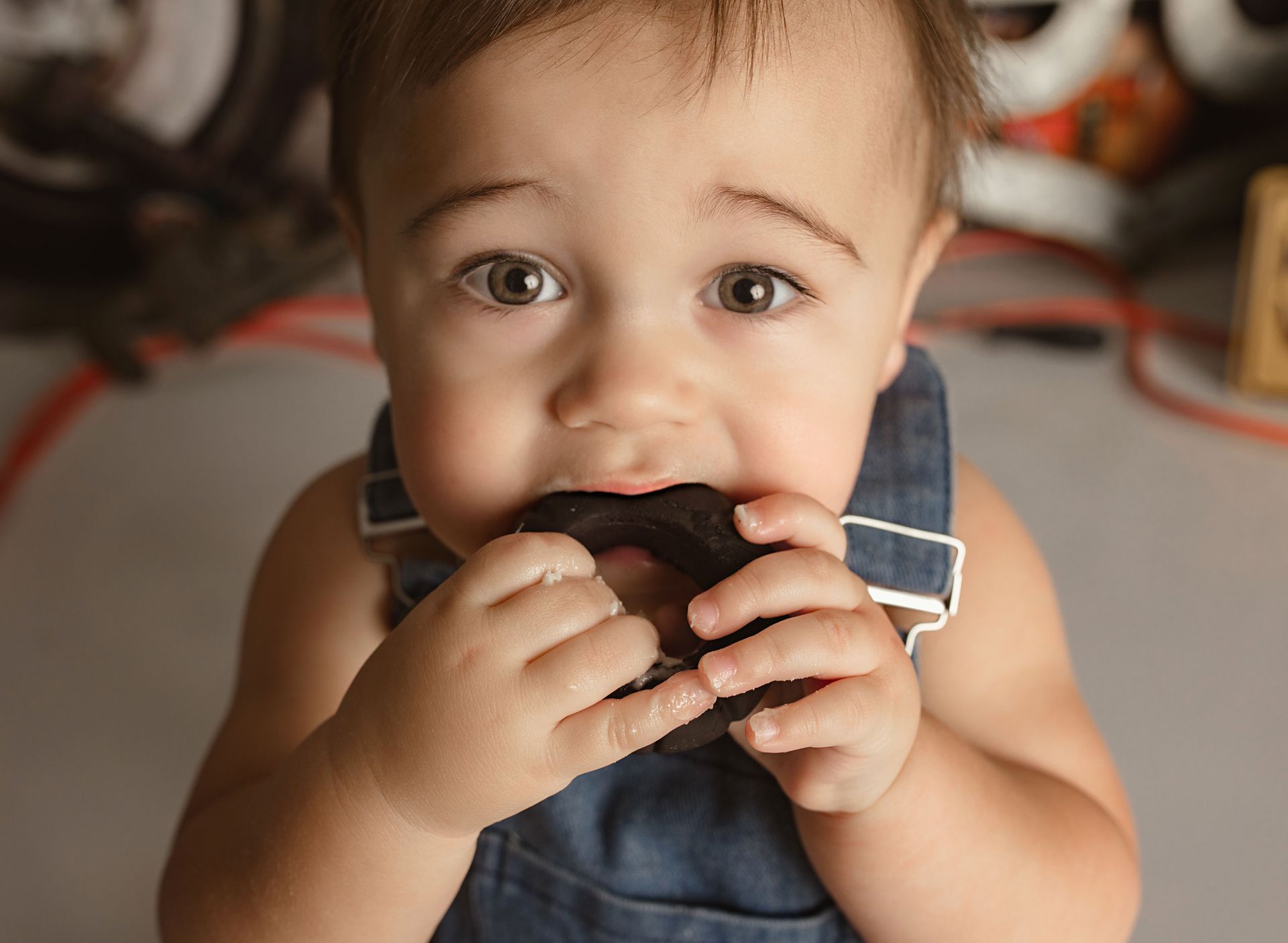 A baby is chewing on a piece of chocolate. Oregon baby photographer