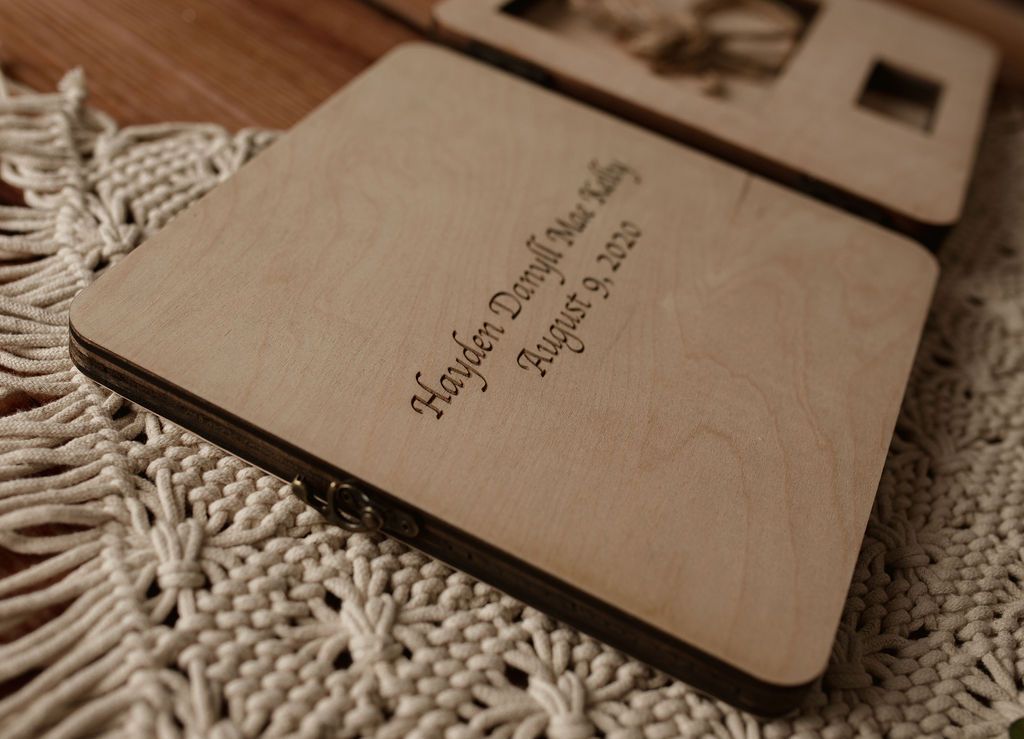 A wooden box with a picture on it is sitting on a table.