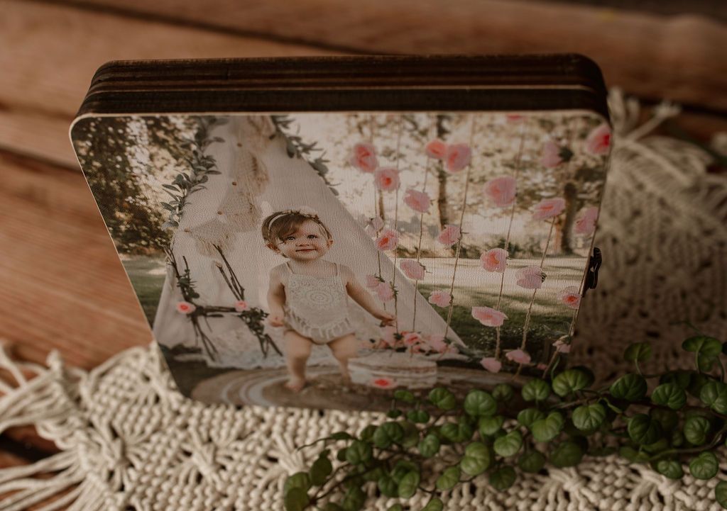 A stack of wooden coasters with a picture of a baby on them.
