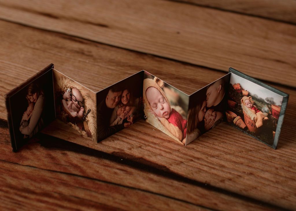 A wooden table with a row of pictures on it.