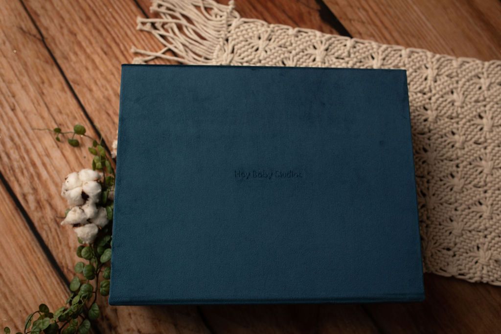 A blue box is sitting on top of a wooden table.