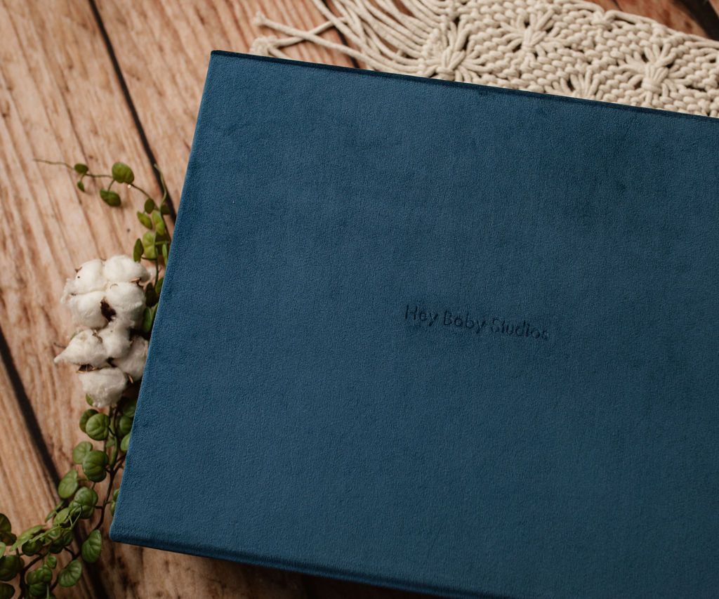 A blue album is sitting on top of a wooden table.