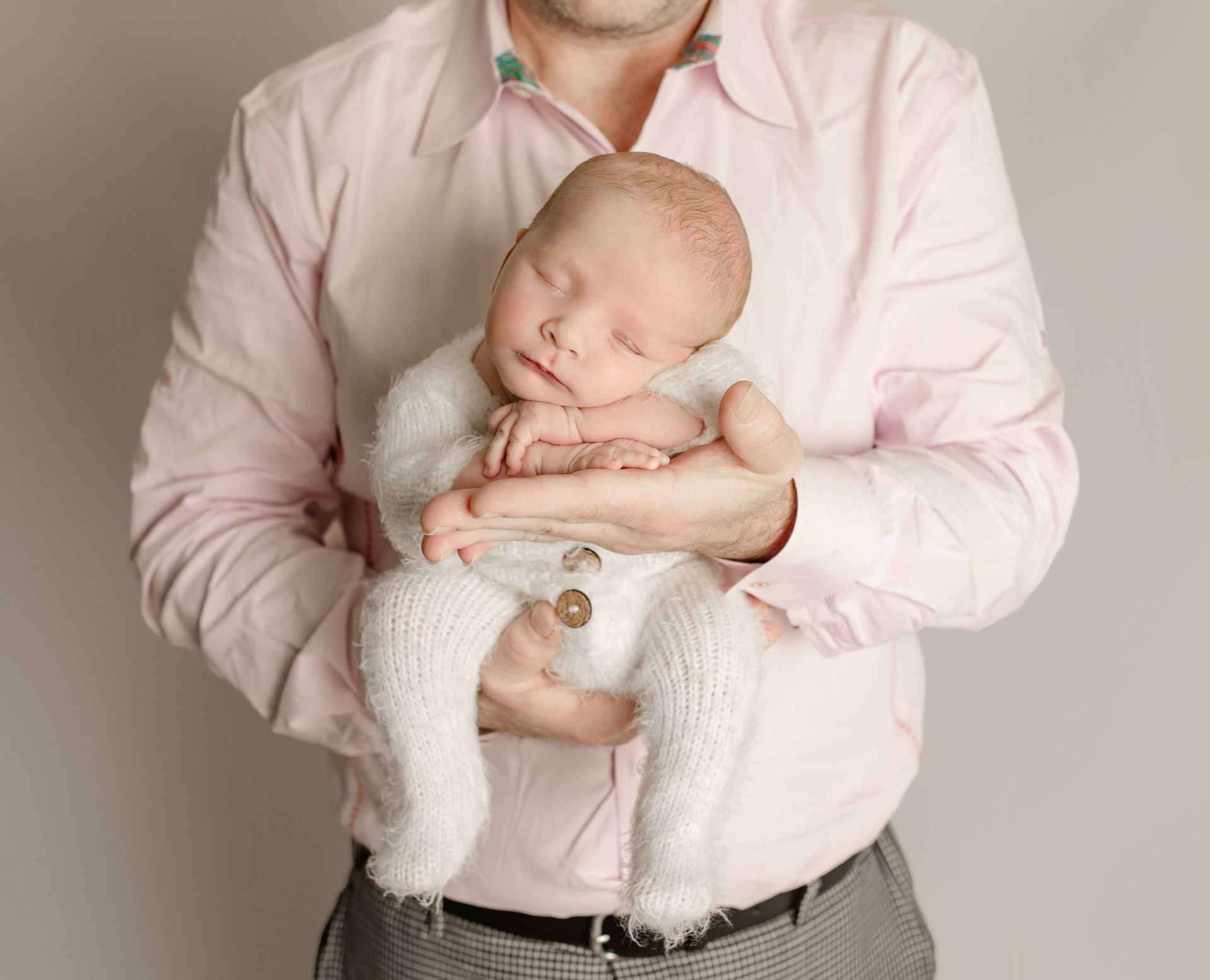 Baby posed in dads hands. Newborn and dad photo ideas.