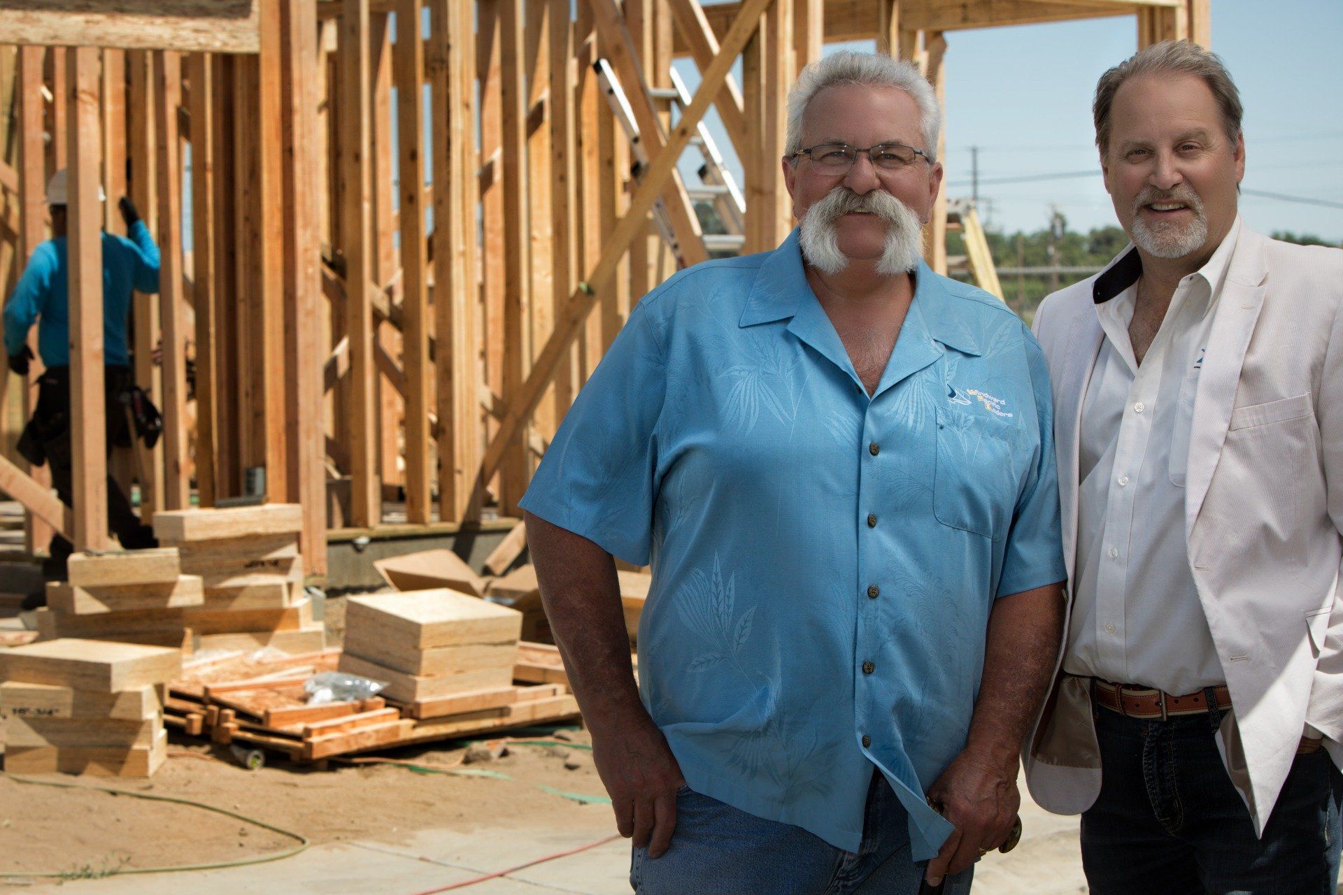 Windward Pacific Builders founders in front of framed house | About Us | Windward Pacific Builders | Modesto, CA 95357
