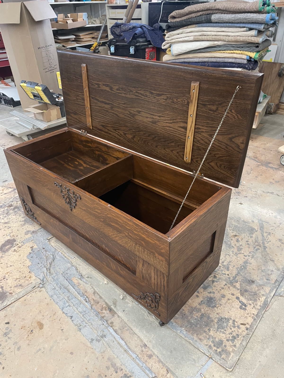 Open wooden storage chest with a compartment, brown finish, hinges visible.