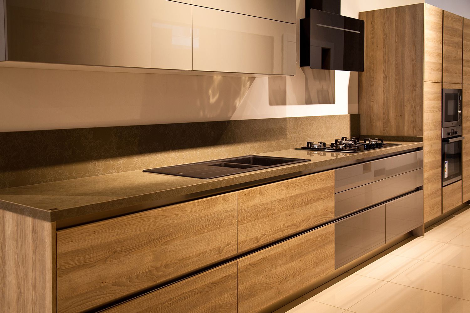 Modern kitchen with wood grain cabinets, stainless steel appliances, and beige countertops.